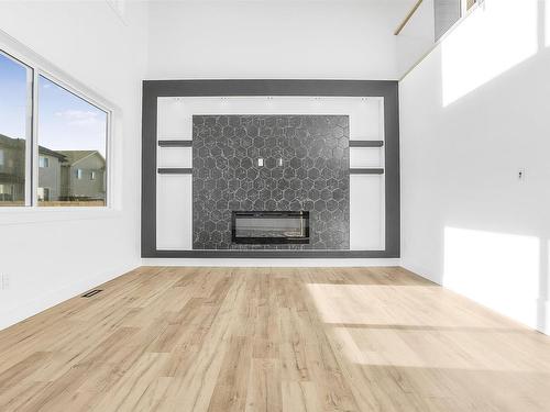 Stony Plain, AB - Indoor Photo Showing Other Room With Fireplace