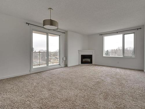 505 10649 Saskatchewan Drive, Edmonton, AB - Indoor Photo Showing Living Room With Fireplace