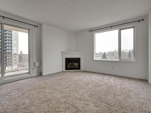 505 10649 Saskatchewan Drive, Edmonton, AB - Indoor Photo Showing Living Room With Fireplace