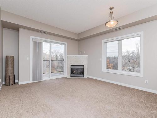 301 9750 94 Street, Edmonton, AB - Indoor Photo Showing Other Room With Fireplace