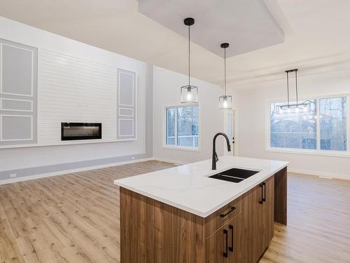 676 Astoria Way, Devon, AB - Indoor Photo Showing Kitchen With Fireplace With Double Sink