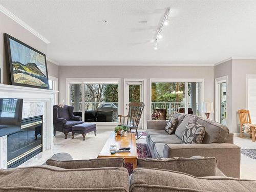 101 11640 79 Avenue, Edmonton, AB - Indoor Photo Showing Living Room With Fireplace