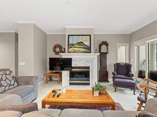 101 11640 79 Avenue, Edmonton, AB - Indoor Photo Showing Living Room With Fireplace