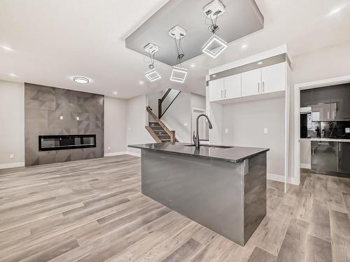 128 Edgewater Circle, Leduc, AB - Indoor Photo Showing Kitchen With Fireplace