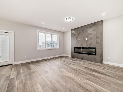 128 Edgewater Circle, Leduc, AB - Indoor Photo Showing Living Room With Fireplace