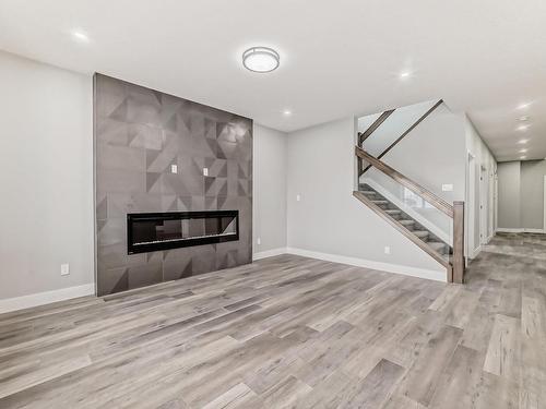 128 Edgewater Circle, Leduc, AB - Indoor Photo Showing Other Room With Fireplace