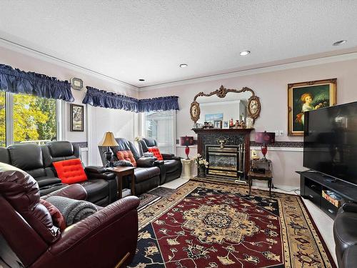 17 Osprey Point(E), St. Albert, AB - Indoor Photo Showing Living Room With Fireplace