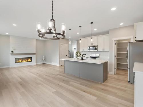 20 Hull Wynd, Spruce Grove, AB - Indoor Photo Showing Kitchen With Fireplace