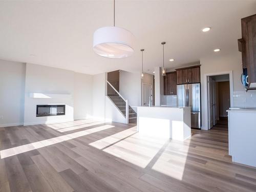 13 Springbrook Wynd, Spruce Grove, AB - Indoor Photo Showing Kitchen With Fireplace