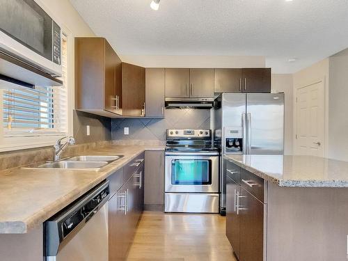 91 Keystone Crescent, Leduc, AB - Indoor Photo Showing Kitchen With Stainless Steel Kitchen With Double Sink