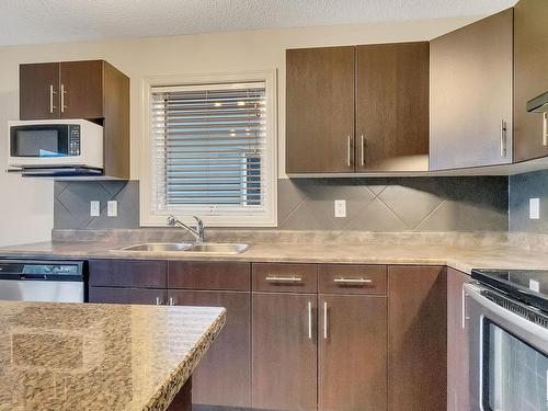 91 Keystone Crescent, Leduc, AB - Indoor Photo Showing Kitchen With Stainless Steel Kitchen With Double Sink