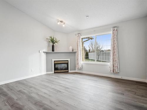 12 4527 55 Avenue, Tofield, AB - Indoor Photo Showing Living Room With Fireplace