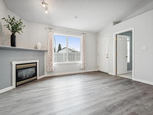 12 4527 55 Avenue, Tofield, AB - Indoor Photo Showing Living Room With Fireplace