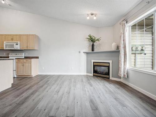 12 4527 55 Avenue, Tofield, AB - Indoor With Fireplace