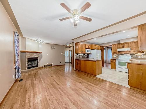 7008 157 Avenue, Edmonton, AB - Indoor Photo Showing Kitchen With Fireplace With Double Sink