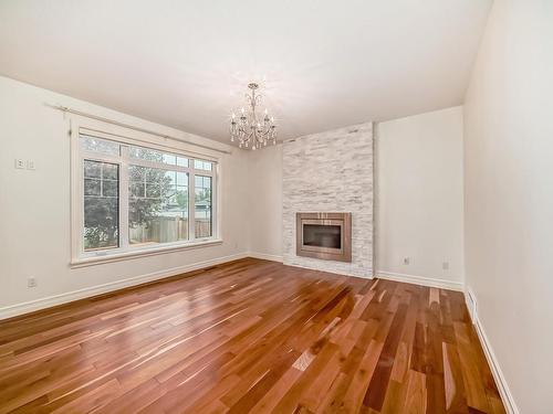 9031 24 Avenue, Edmonton, AB - Indoor Photo Showing Living Room With Fireplace