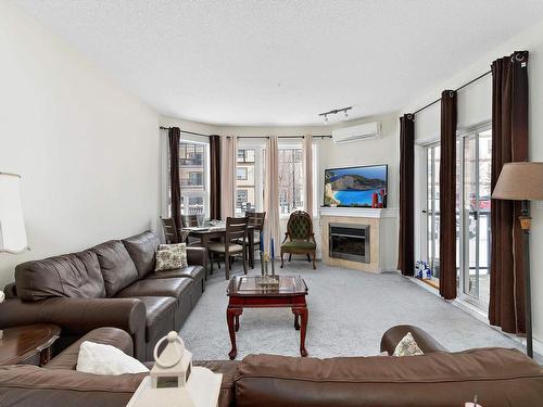 116 2035 Grantham Court, Edmonton, AB - Indoor Photo Showing Living Room With Fireplace