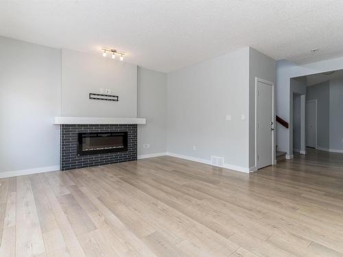 4613 66 Street, Beaumont, AB - Indoor Photo Showing Living Room With Fireplace