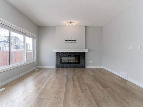 4613 66 Street, Beaumont, AB - Indoor Photo Showing Living Room With Fireplace