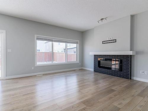 4613 66 Street, Beaumont, AB - Indoor Photo Showing Living Room With Fireplace