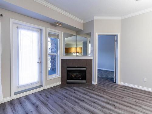 122 8528 82 Avenue, Edmonton, AB - Indoor Photo Showing Living Room With Fireplace