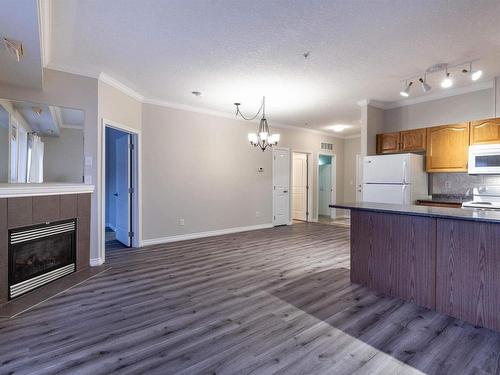 122 8528 82 Avenue, Edmonton, AB - Indoor Photo Showing Kitchen With Fireplace