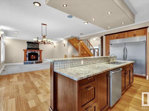 27 Kingdom Place, Leduc, AB - Indoor Photo Showing Kitchen With Fireplace With Double Sink