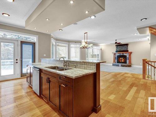 27 Kingdom Place, Leduc, AB - Indoor Photo Showing Kitchen With Fireplace With Double Sink