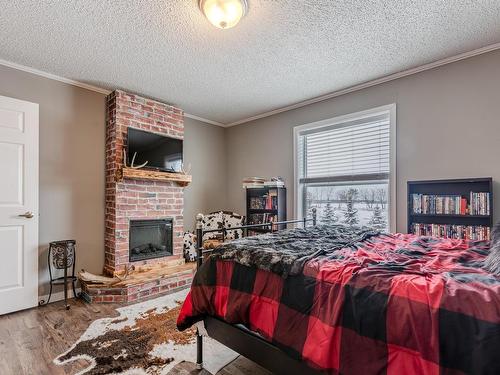 5228 Twp Rd 564, Rural Lac Ste. Anne County, AB - Indoor Photo Showing Bedroom With Fireplace