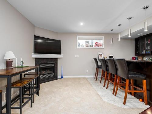 1257 Westerra Crescent, Stony Plain, AB - Indoor Photo Showing Dining Room With Fireplace