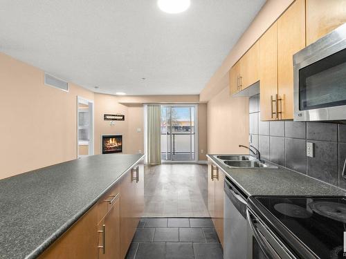 210 10118 106 Avenue, Edmonton, AB - Indoor Photo Showing Kitchen With Fireplace With Double Sink