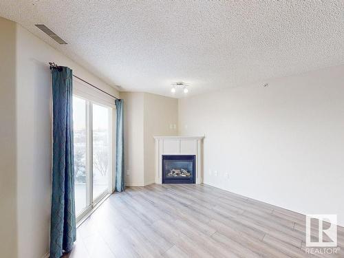 418 16035 132 Street, Edmonton, AB - Indoor Photo Showing Living Room With Fireplace