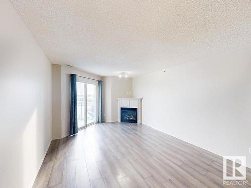 418 16035 132 Street, Edmonton, AB - Indoor Photo Showing Living Room With Fireplace