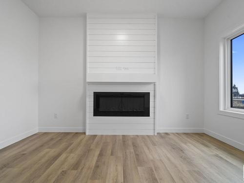 187 Starling, Fort Saskatchewan, AB - Indoor Photo Showing Living Room With Fireplace