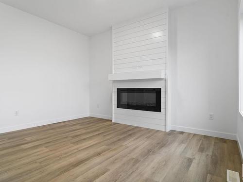 187 Starling, Fort Saskatchewan, AB - Indoor Photo Showing Living Room With Fireplace