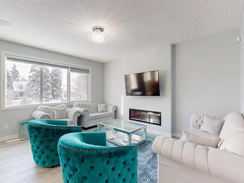 215 Glenridding Ravine Rd, Edmonton, AB - Indoor Photo Showing Living Room With Fireplace