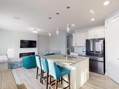 215 Glenridding Ravine Rd, Edmonton, AB - Indoor Photo Showing Kitchen With Fireplace With Double Sink With Upgraded Kitchen