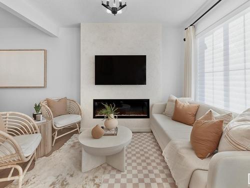 100 1025 Secord Promenade, Edmonton, AB - Indoor Photo Showing Living Room With Fireplace