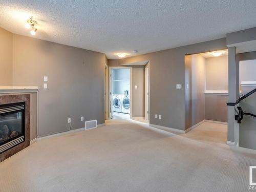 7669 Schmid Crescent, Edmonton, AB - Indoor Photo Showing Other Room With Fireplace