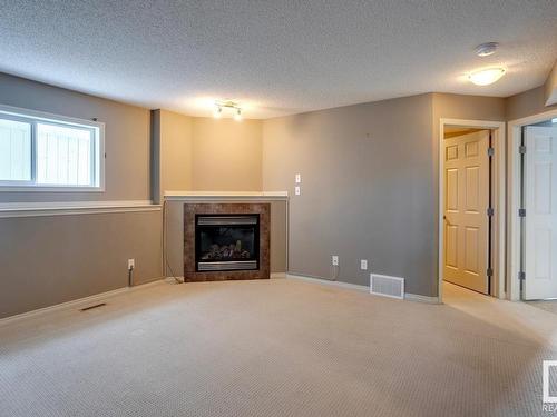 7669 Schmid Crescent, Edmonton, AB - Indoor Photo Showing Living Room With Fireplace