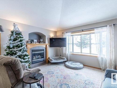 674 Kananaskis Drive, Devon, AB - Indoor Photo Showing Living Room With Fireplace