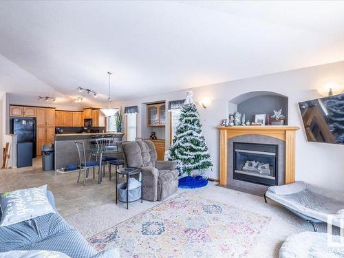 674 Kananaskis Drive, Devon, AB - Indoor Photo Showing Living Room With Fireplace