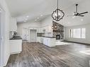 311 55504 Rr 13, Rural Lac Ste. Anne County, AB  - Indoor Photo Showing Kitchen With Fireplace 