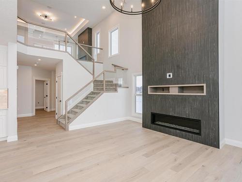 202 Edgewater Circle, Leduc, AB - Indoor Photo Showing Other Room With Fireplace