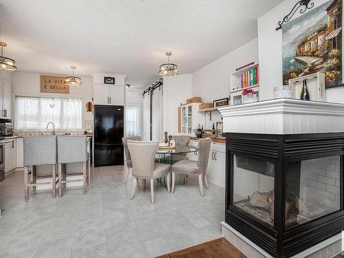 4893 Terwillegar Common, Edmonton, AB - Indoor Photo Showing Dining Room With Fireplace