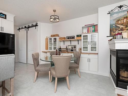 4893 Terwillegar Common, Edmonton, AB - Indoor Photo Showing Dining Room With Fireplace