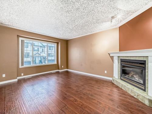 28 225 Blackburn E, Edmonton, AB - Indoor Photo Showing Living Room With Fireplace