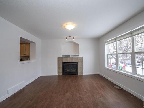 883 Oakland Boulevard, Devon, AB - Indoor Photo Showing Living Room With Fireplace