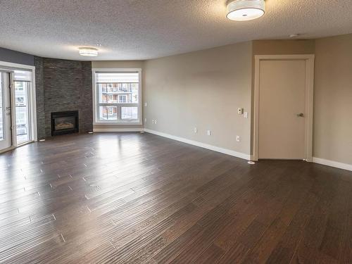 405 7951 96 Street, Edmonton, AB - Indoor Photo Showing Living Room With Fireplace