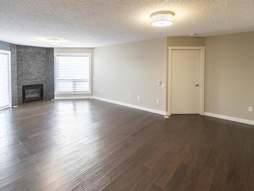 405 7951 96 Street, Edmonton, AB - Indoor Photo Showing Living Room With Fireplace